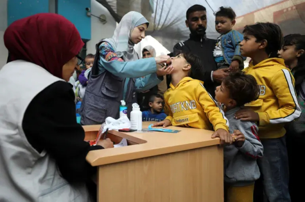 Palestinian children are vaccinated against polio during the second round of a vaccination campaign in Gaza City, November 2, 2024 [Dawoud Abu Alkas/ Reuters]