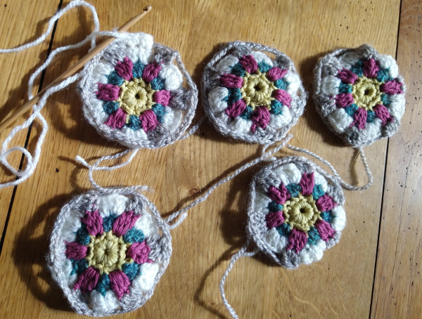 Five small circular crochet motifs 