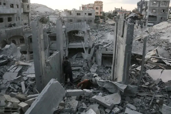 People search through the rubble following Israeli strikes in the Nuseirat refugee camp, central Gaza [File: Eyad Baba/AFP]