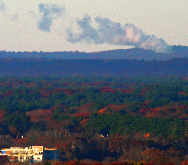 A distant wildfire with a large smoke cloud photographed from Buck Hill.