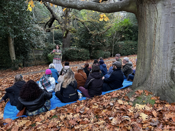 A far away shot just Vanessa mid story and the audience in a faintly sinister looking corner of the park . They 