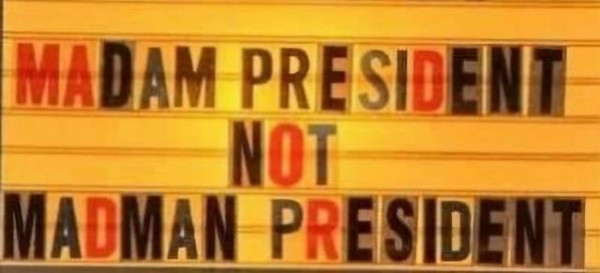 Sign saying "MADAM PRESIDENT NOT MADMAN PRESIDENT"