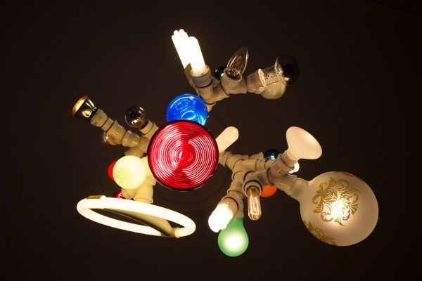 Hanging sculpture composed of many different types of lightbulbs in clusters