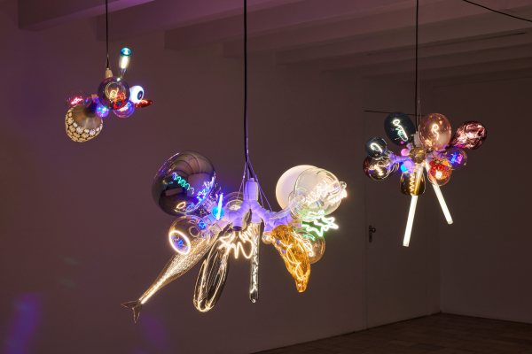 Hanging sculpture composed of many different types of lightbulbs in clusters