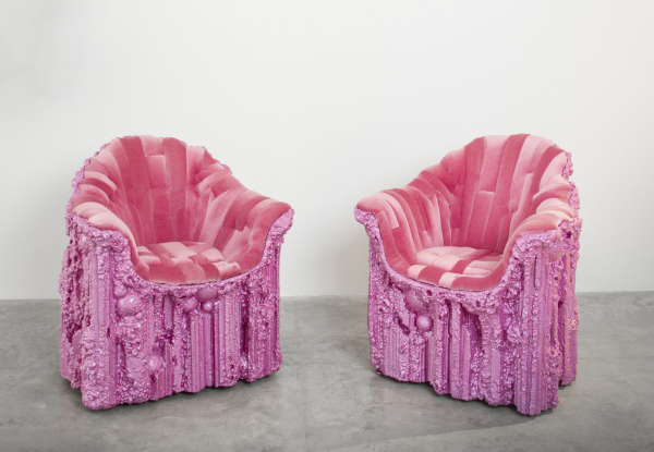 Two pink and fuchsia armchairs with a mixture of hard and soft materials 