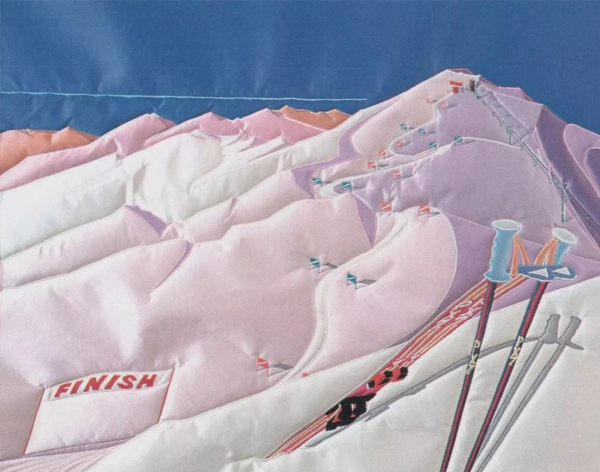 Embroidered scene on silk fabric, showing snow-covered mountain with skiiers racing down a course, in a soft purple-pink palette