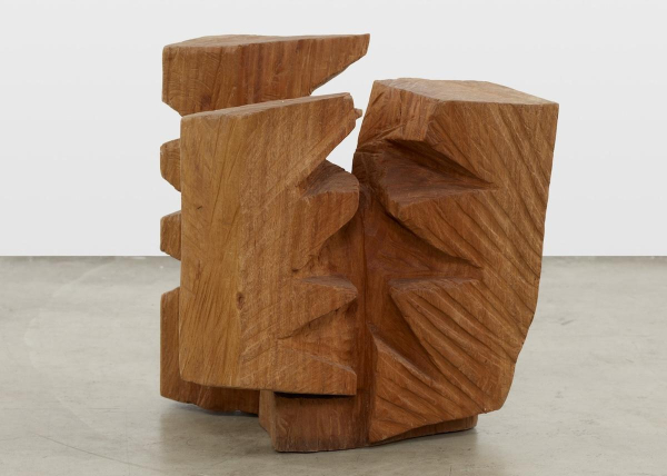 Abstract wooden sculpture in a three-part blocky shape with carved zigzag incisions