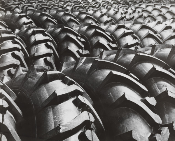 Black and white photo of rows and rows of large tires lined up against one another