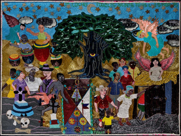 Hanging beaded textile work illustrating several scenes including a drummer performance, a funeral, and a group of people being visited by angels, all organized around a large dark tree with a glowing eye in its trunk.