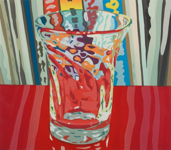 Print of a narrow glass sitting on a red surface with books behind it, with colors reflecting and refracting in the glass