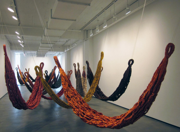 Installation of a series of hammock sculptures in natural autumnal tones