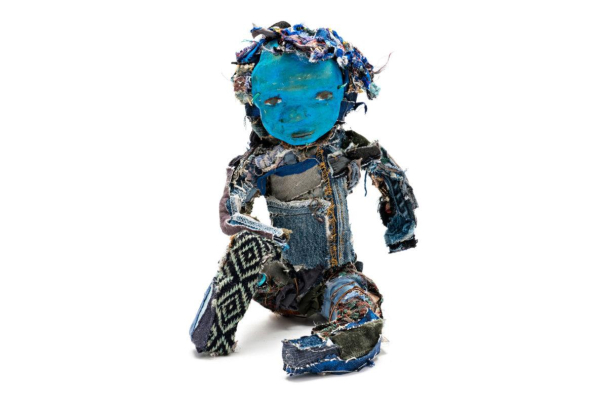 Sculptural figure made up of denim and other textiles, with a blue clay face