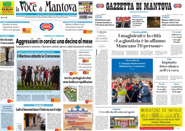 L'immagine mostra la prima pagina di un giornale. In alto a sinistra c'è il titolo "La Voce di Mantova" e a destra "Gazzetta di Mantova". Sotto i titoli ci sono vari articoli e immagini. Alcuni dei titoli leggibili includono "Aggressioni in corsia: una decina al mese" e "Il Mantova abbatte la Cremonese". C'è anche una sezione pubblicitaria in basso a destra con il testo "Mercatini di Natale". 