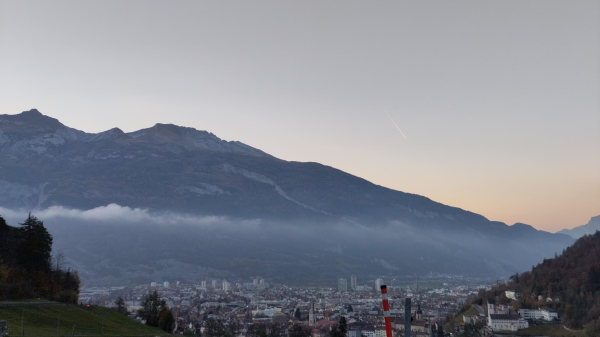 View of chur city in evening light with some clouds