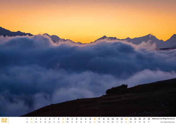 Photograph of a blue cloud ocean, between a nearby slope and distant mountain peaks. The sky is an intense post-sunset yellow.