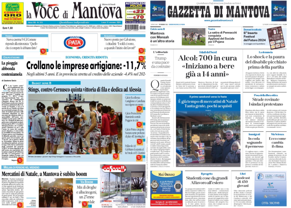 La foto mostra due pagine di giornale affiancate su uno schermo. A sinistra c'è "La Voce di Mantova" e a destra "Gazzetta di Mantova".   Sulla prima pagina de "La Voce di Mantova", il titolo principale è "Crollano le imprese artigiane: -11,7%". Sotto il titolo c'è un'immagine di una squadra di basket con la didascalia che menziona una vittoria contro Cernusco. In basso, un altro titolo parla di un boom dei mercatini di Natale a Mantova.  Sulla prima pagina della "Gazzetta di Mantova", il titolo principale è "Alcol: 700 in cura 'Iniziano a bere già a 14 anni'". C'è anche un'immagine di un mercato natalizio con un titolo che parla del tempo dei mercatini di Natale. Altri articoli menzionano argomenti come la paura di un disabile picchiato prima della partita e un'indagine sui prezzi delle case.  .