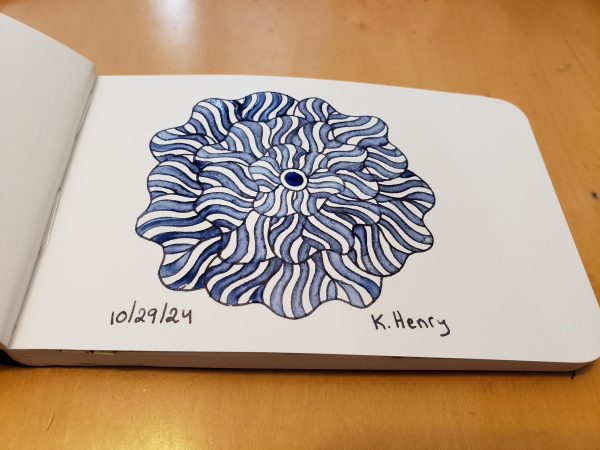 Hand drawn generative art in ink on an open page of my sketchbook. The abstract pattern is floral inspired.