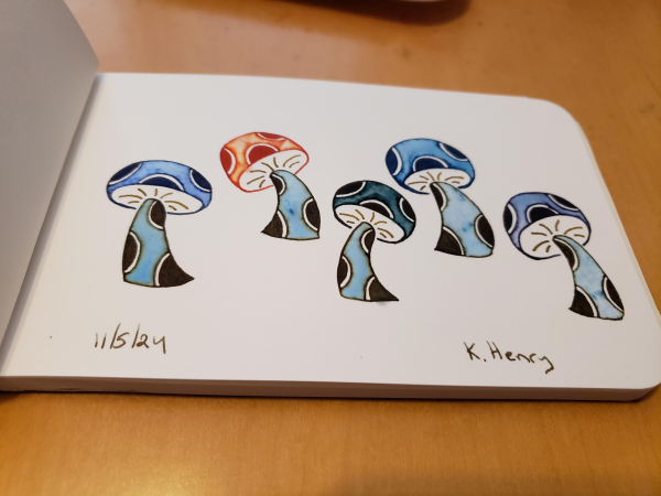 Hand drawn generative/procedural art in ink on an open page of my sketchbook. The abstract pattern looks like five mushrooms with polka dots on their stems and caps.