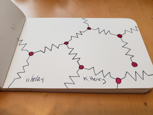 Hand drawn generative/procedural art in ink on an open page of my sketchbook. The abstract pattern looks a bit like a network with resistor symbols connecting the nodes.