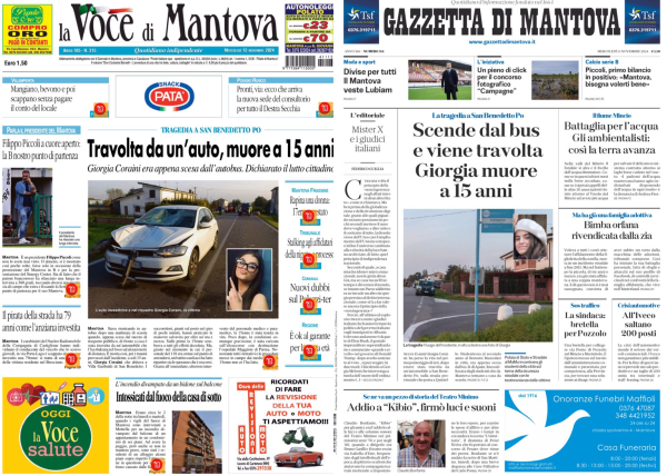 La foto mostra due pagine di giornale affiancate su uno schermo. A sinistra c'è "La Voce di Mantova" e a destra "Gazzetta di Mantova". Entrambi i giornali riportano la stessa notizia principale riguardante una ragazza di nome Giorgia, di 15 anni, che è stata travolta da un'auto ed è morta. La pagina di sinistra ha un'immagine di un'auto e una foto di una ragazza con occhiali. La pagina di destra ha una foto di una ragazza sorridente e un'altra immagine di un luogo stradale. Entrambe le pagine contengono vari articoli e annunci pubblicitari.  .