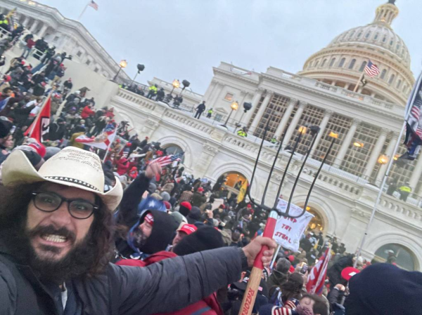 Photo: scenes photographed in Washington from Jan 6, a large crown with a man in the front holding a pitchfork.