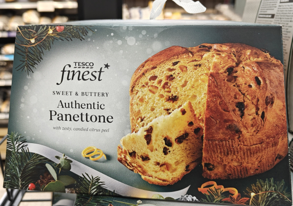 A photograph of a product on sale in Tesco. It shows a box with the writing on it "Tesco Finest sweet & buttery Authentic Panettone" with a photograph of panettone, a sweet bread filled raisins and peel probably from Italy, next to the writing. It is unlikely the panettone is authentic.