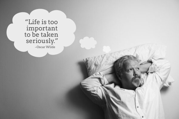 Black and white photo of Mark , with hands folded behind head on a pillow, thinking: "Life is too important to be taken seriously." –Oscar Wilde