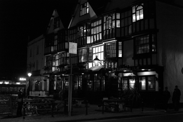 The pub windows are illuminated on  November evening