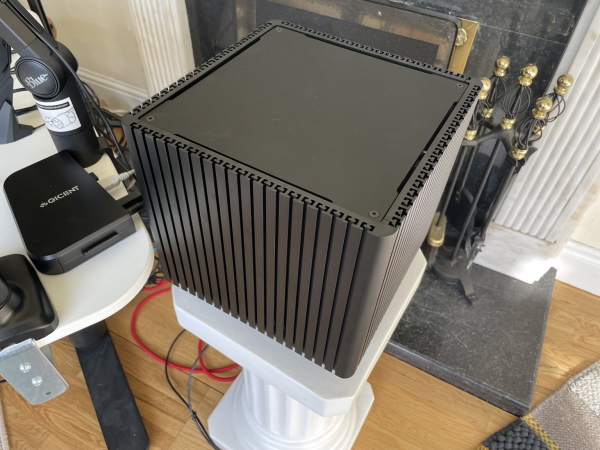 Photo of a space black cube PC resting on a column.

It’s comprised of:

- Streacom ST-DB4 Black Fanless Aluminium Bi-Symmetrical ITX Chassis
- Gigabyte B550I AORUS PRO AX AM4 Mini-ITX Motherboard
- AMD Ryzen 7 5700G 3.8GHz 8C/16T 65W AM4 APU with Radeon Graphics 8
- Corsair Vengeance LPX 64GB (2x32GB) DDR4 3200MHz Memory
- Arctic Silver AS5 12g, High-Density Polysynthetic Silver Thermal Compound
- Streacom ST-LH6 Additional CPU Cooling Kit for DB4
- Streacom ST-ZF240 ZeroFlex 240W Passive PSU
- Quiet PC IEC C13 UK Mains Power Cord, 1.8m (Type G)
- Samsung 980 PRO 1TB PCIe 4.0 M.2 NVMe SSD (7000/5000)
- SupaHub PCIe to 4x Type A and 1x Type C USB Card