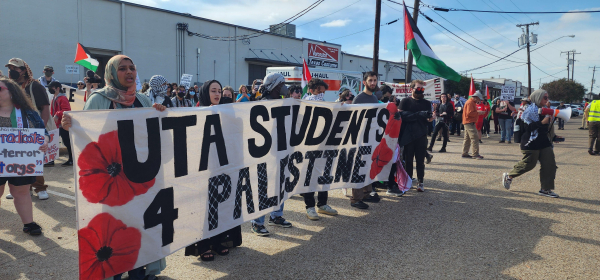 Activists with a banner in a parking lot: UTA Students 4 Palestine 