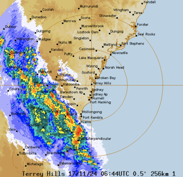 A screenshot of the rain radar for Sydney, there's a very tall band of angry red storm making its way from west to east.