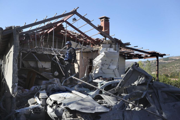 A journalist observes the site where an Israeli airstrike hit a compound housing journalists, killing three media staffers from two different news agencies according to Lebanon’s state-run National News Agency, in Hasbaya village, southeast Lebanon, Friday, Oct. 25, 2024.  AP Photo/Mohammed Zaatari, File 