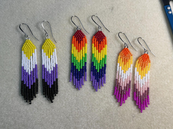 Three pairs of mini pride beaded fringe earrings, in the colors of the non-binary pride flag, rainbow pride flag, and lesbian pride flag.