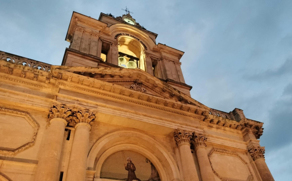 Church of San Francesco d'assisi, in the picture, columns, the church's clock and cross on the bell tower are visible