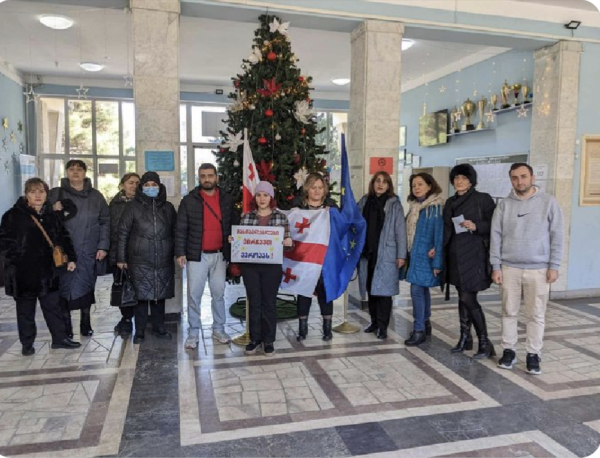 Staff at a school in Tbilisi Georgia stand in the entrance as they call a strike.