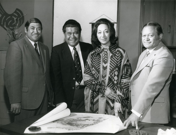 Whetu Tirikātene-Sullivan with three male cabinet ministers. She is a Māori woman wearing a bold-patterned dress. The men are all in suits.