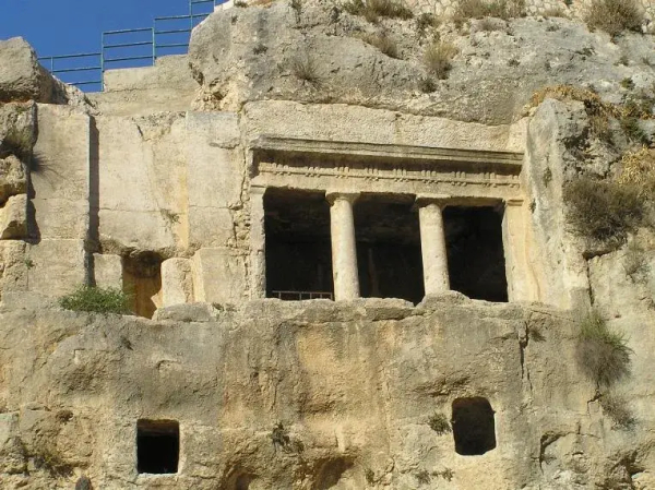 This image appears to depict an ancient rock-cut structure, likely a tomb or temple, featuring columns and a carved facade. It is situated in a rocky area, showcasing the architectural style typical of ancient civilizations that utilized natural materials for construction. The presence of columns suggests a degree of artistry and significance. Such structures are often found in historical archaeological sites.

Image Credits: Wikimedia / No machine-readable author provided. Eman assumed (based on copyright claims). / Public domain