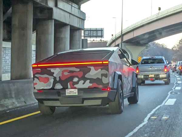 acybertruck painted "urban camo" colors red, gray, gray, and gray