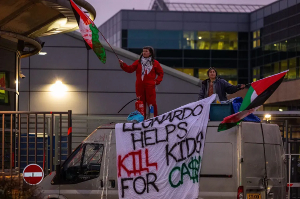 On 10th December 2024 
Outside Leonardo military industrial complex suppliers in Edinburgh Palestine Action members wave Palestine flags and stand on vehicle blocking road entrance gate 
Their banner 
LEONARDO HELPS KILL KIDS FOR CASH 