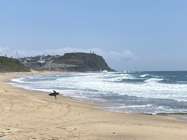 Different surfer, leaving the water on the same stretch of beach (same day).