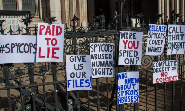 Placards outside the Royal Courts of Justices, Reading Variously ‘paid to lie’ and ‘complete deceit = no consent’