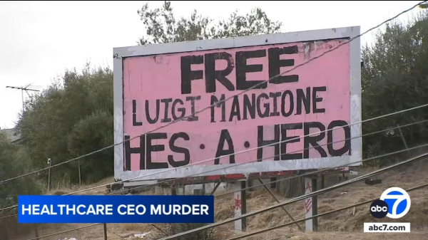 Billboard text:
FREE
Luigi Mangione 
He’s A Hero 