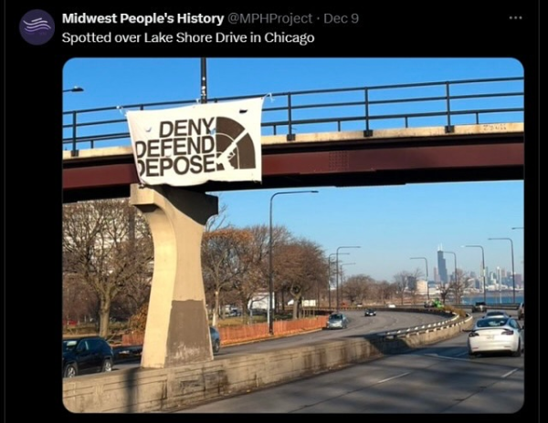 Banner hung from public road bridge
Text:
DENY 
DEFEND 
DEPOSE