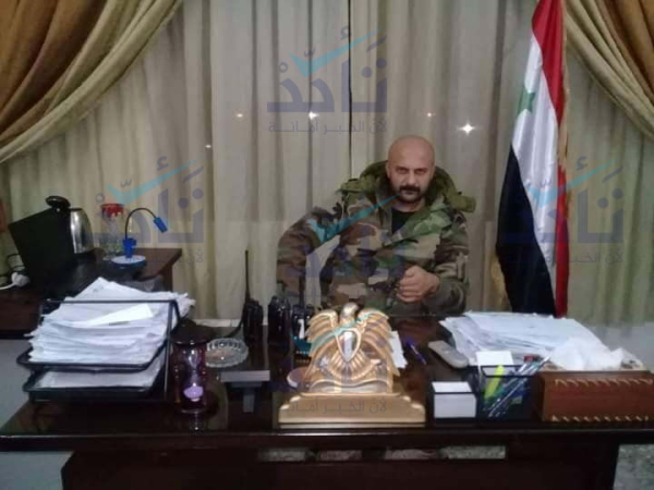 Photo from Salameh Mohammad Salameh in his office, dressed in full military uniform. 