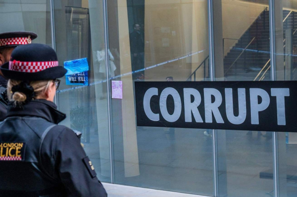 Photo of two police officers outside an extinction Rebellion protest, caption ‘2nd Mar, 2023. Extinction Rebellion protest in the City of London over financial lobbying for the fossil fuel industries. Photo: Guy Bell/Alamy Live News
‘