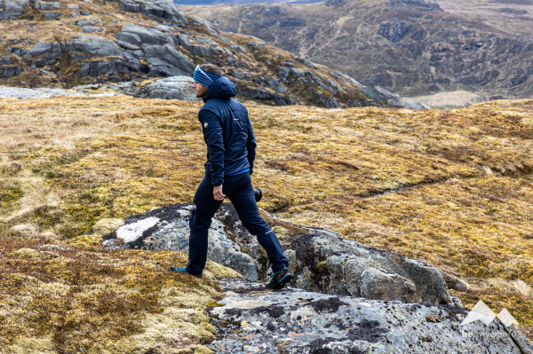 Falko Burghausen walking with a camera in his hand to find the next spot for landscape photography on Lofoten Islands