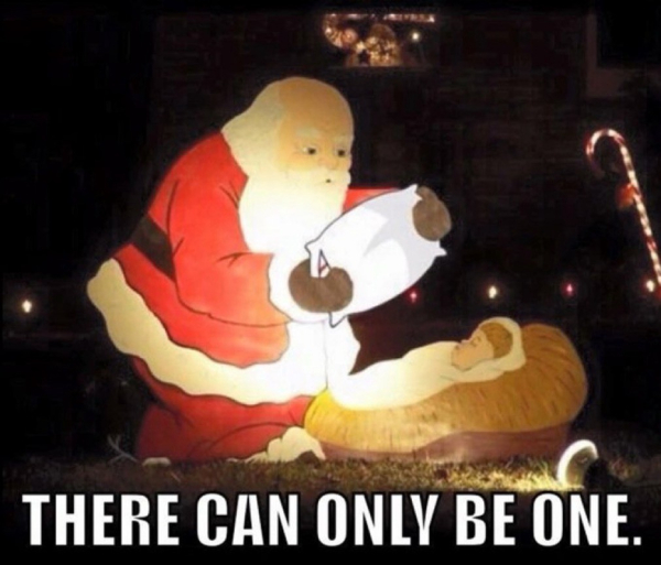 Lawn display of Santa holding a pillow over the baby Jesus in his creche with caption: There can be only one