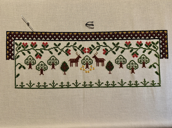 Partially completed cross stitch sampler. Decorative border, leaves, trees and stags. 