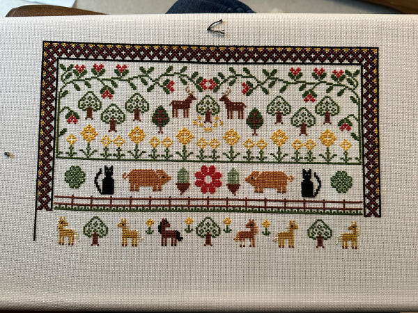 A partially completed cross stitch sampler. At the bottom there are six ponies- two Haflingers, a bay, a chestnut and another two Haflingers 