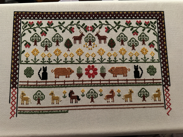 Work in progress cross stitch samplers. Lots of animals and trees. Ponies at the bottom are starting to have a fence out underneath them. 